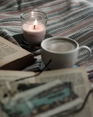 Sample ad, portrait: a lit candle beside a cup of coffee and an open book.