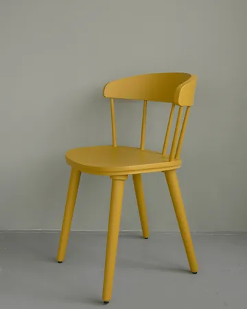 Sample ad for a home goods shop: a yellow wooden chair against a pale wall.